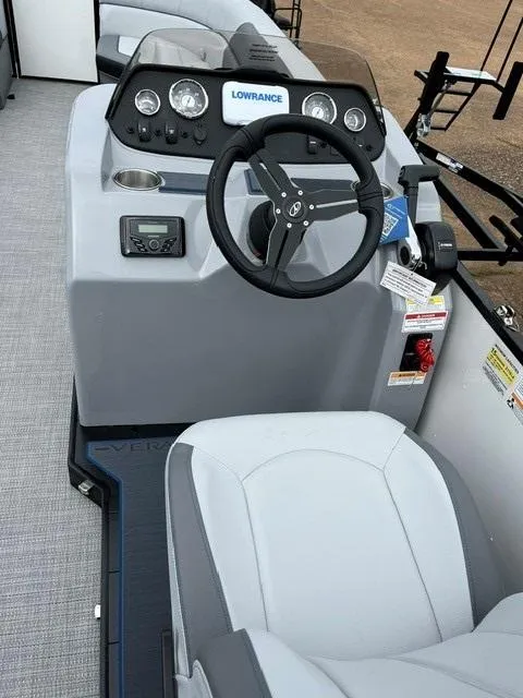 Slide: The Image of 2025 Veranda Vista Sport 25RC boat dashboard with steering wheel and control panel. - 10