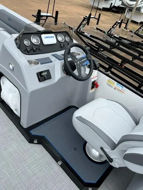 Slide: The Image of 2025 Veranda Vista Sport 25RC boat cockpit with steering wheel and control panel. - 11