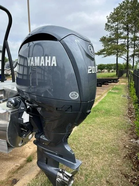 Slide: The Image of 2025 Veranda Vista Sport 25RC with Yamaha 200 outboard motor, parked outdoors. - 6