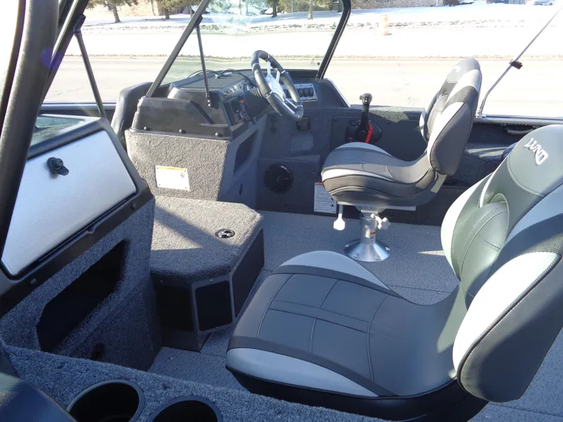 Slide: The Image of Interior of 2025 Lund 1875 Impact XS Sport boat with modern seating and dashboard. - 14