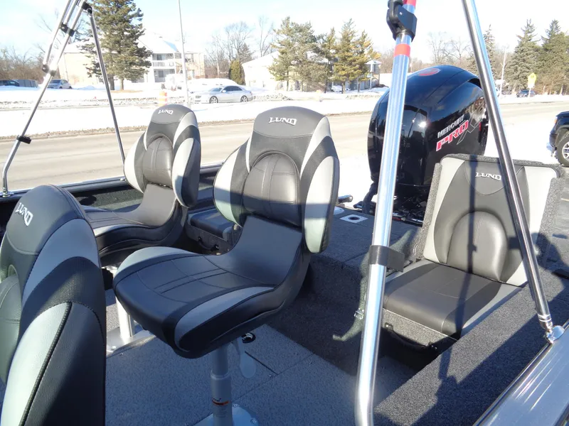 Slide: The Image of 2025 Lund 1875 Impact XS Sport boat interior with comfortable seating and modern design. - 15