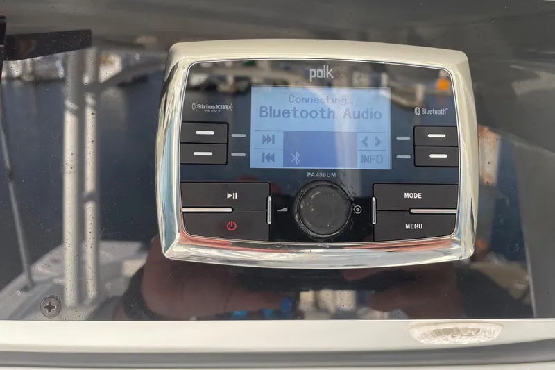 Slide: The Image of Polk Bluetooth audio system on 2015 Edgewater 280CC boat dashboard. - 12