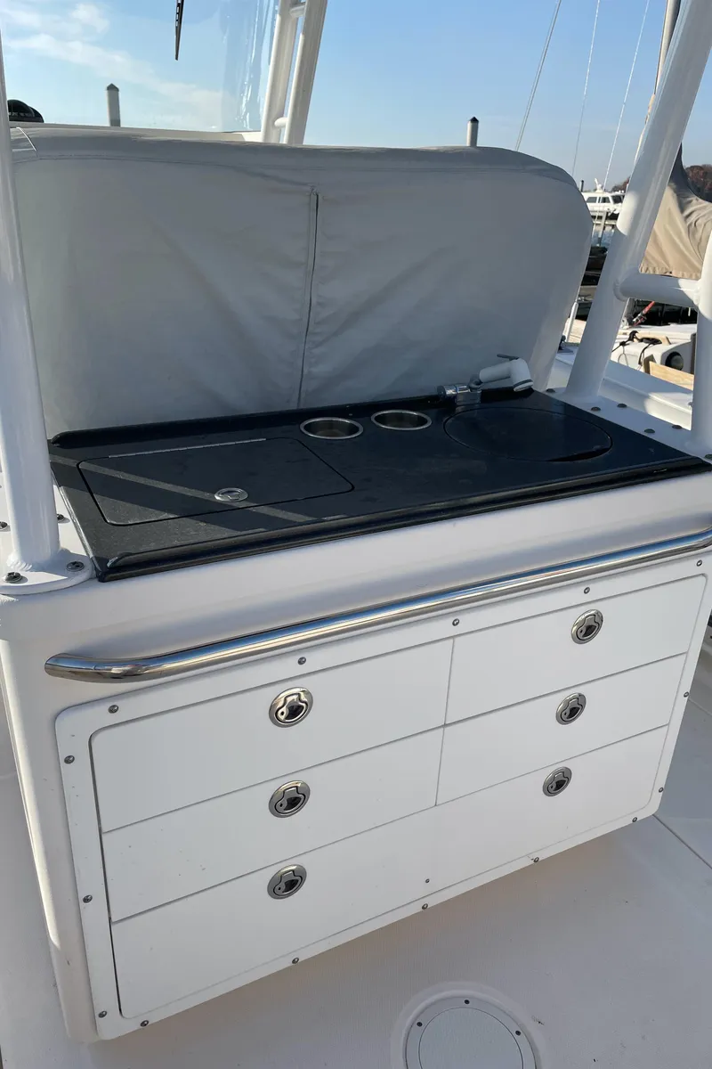 Slide: The Image of 2015 Edgewater 280CC boat with storage drawers and countertop. - 14
