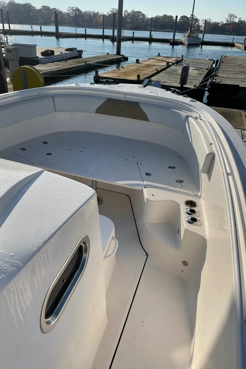 Slide: The Image of 2015 Edgewater 280CC boat docked at marina, sunny day. - 16