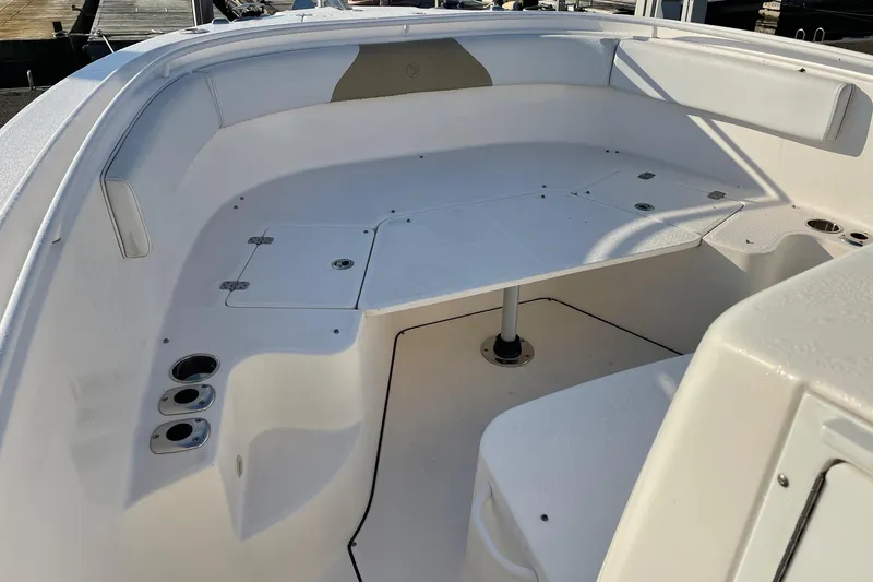 Slide: The Image of 2015 Edgewater 280CC boat interior with seating and cup holders. - 17
