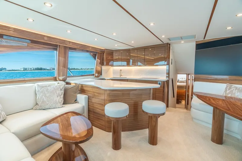Slide: The Image of Luxurious interior of 2025 Viking 54 Convertible yacht with modern furnishings and ocean view. - 19