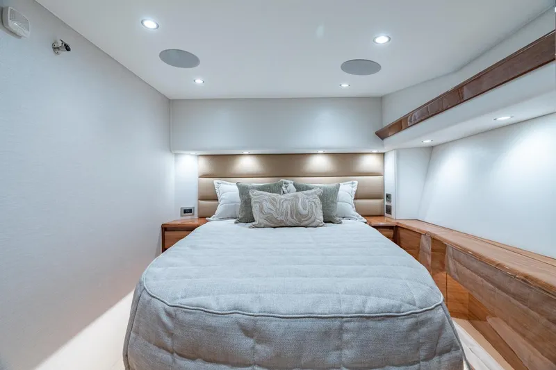 Slide: The Image of Luxurious bedroom interior of 2025 Viking 54 Convertible yacht, featuring elegant lighting and modern design. - 26