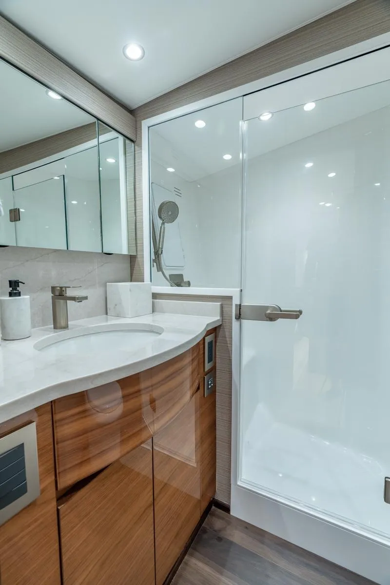 Slide: The Image of Modern bathroom interior in 2025 Viking 54 Convertible yacht, featuring sleek design and glass shower. - 27