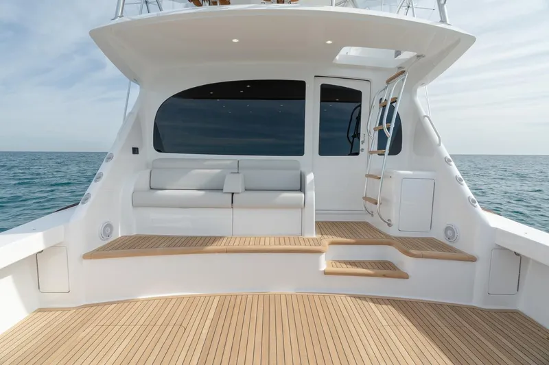 Slide: The Image of 2025 Viking 54 Convertible yacht deck with seating and ocean view. - 3