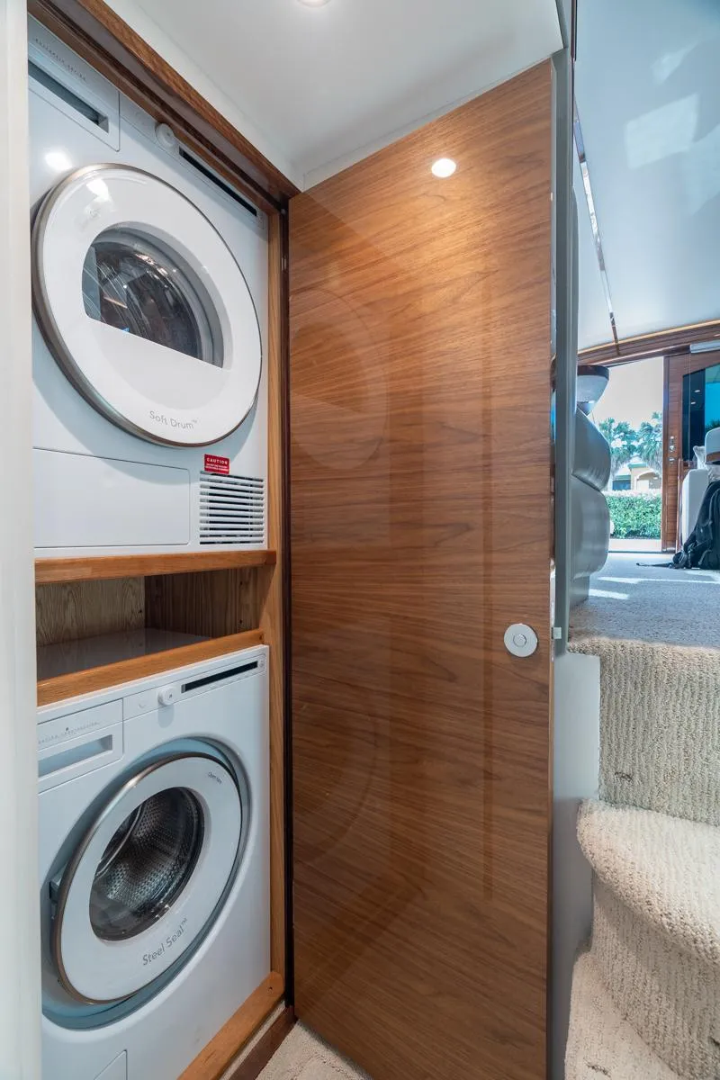 Slide: The Image of Laundry area in 2025 Viking 54 Convertible yacht with stacked washer and dryer. - 30