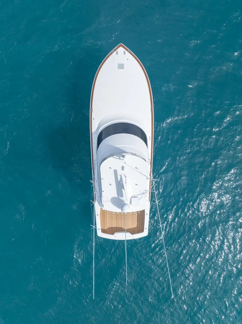 Slide: The Image of Aerial view of 2025 Viking 54 Convertible yacht on blue ocean water. - 36