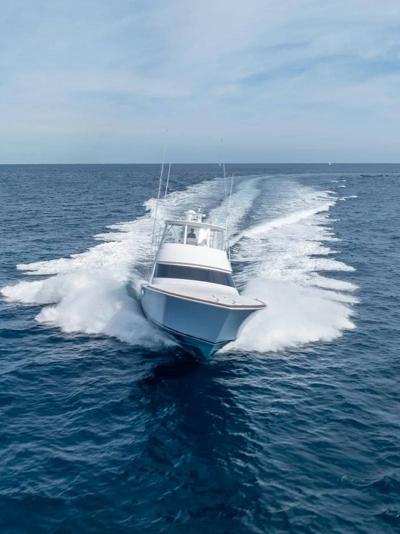Slide: The Image of 2025 Viking 54 Convertible yacht cruising swiftly on open ocean waters. - 37