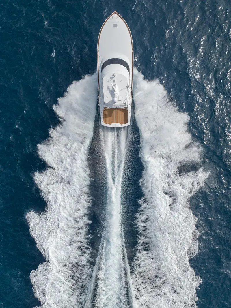 Slide: The Image of Aerial view of 2025 Viking 54 Convertible yacht cruising through ocean waves. - 38