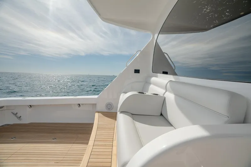 Slide: The Image of 2025 Viking 54 Convertible yacht with sleek seating and ocean view. - 8