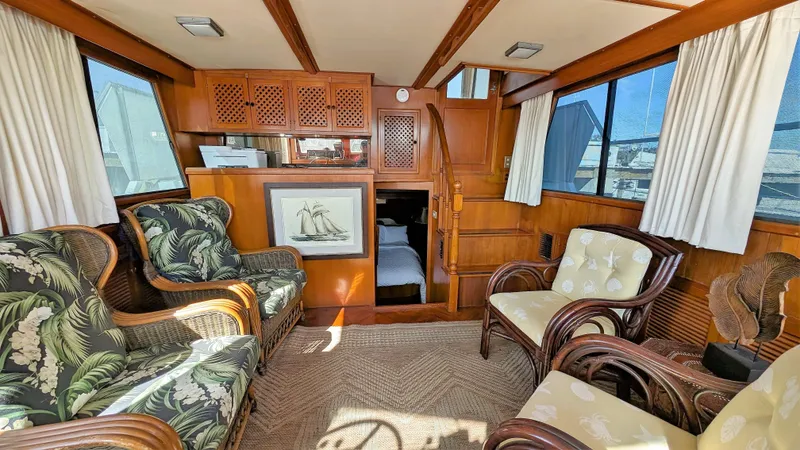 Slide: The Image of Interior of 1986 Heritage East 40 Sundeck yacht with wicker furniture and nautical decor. - 10