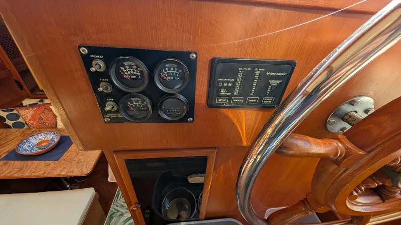 Slide: The Image of Control panel and steering wheel of 1986 Heritage East 40 Sundeck boat interior. - 16