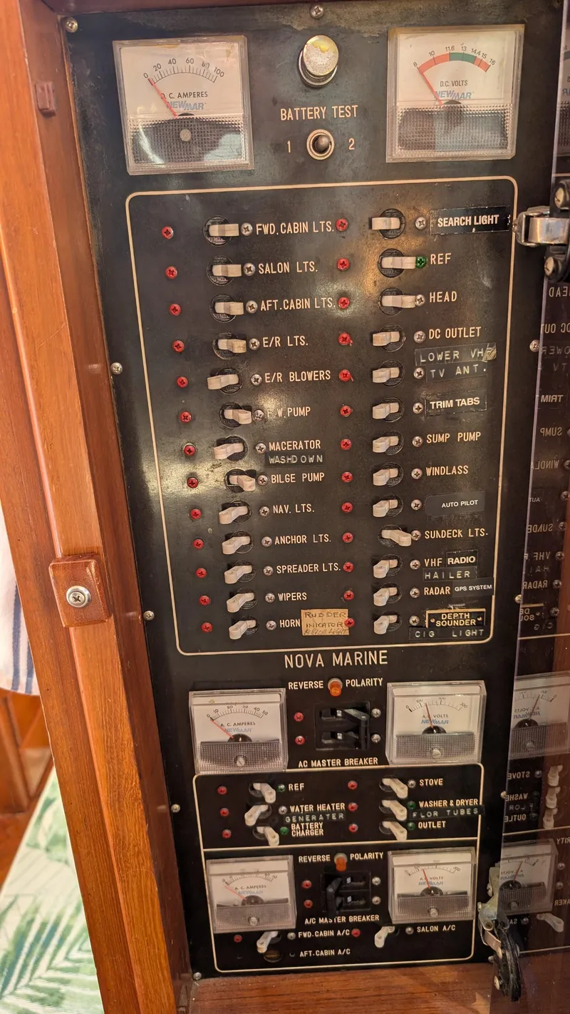 Slide: The Image of Control panel of a 1986 Heritage East 40 Sundeck boat with various switches and gauges. - 17