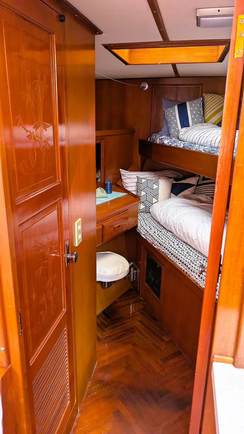 Slide: The Image of 1986 Heritage East 40 Sundeck interior with wooden finish and cozy bunk beds. - 24
