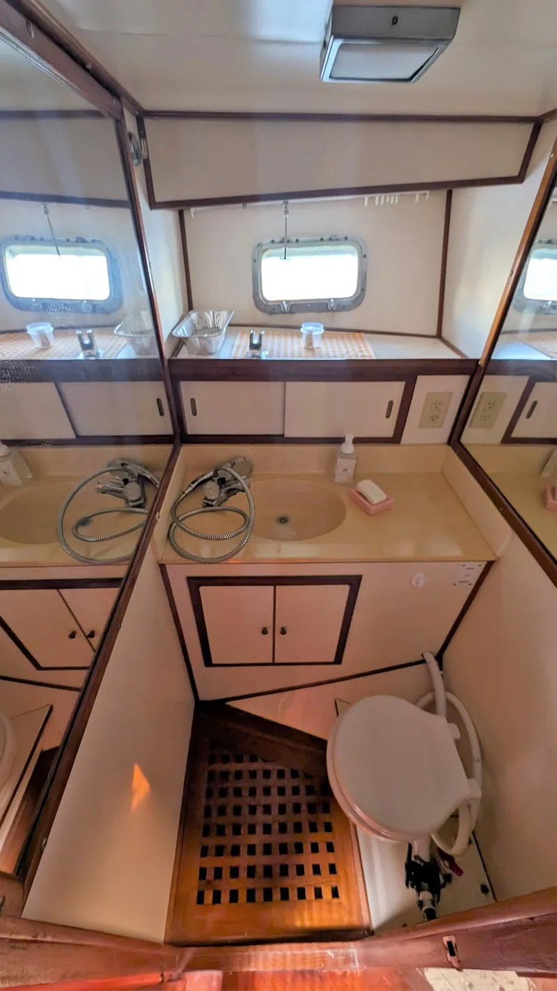 Slide: The Image of 1986 Heritage East 40 Sundeck bathroom with sink, mirror, and toilet. - 26