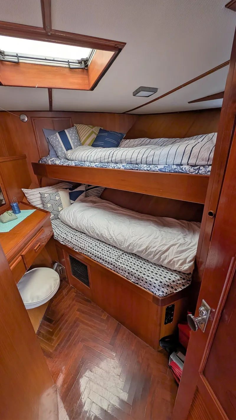 Slide: The Image of 1986 Heritage East 40 Sundeck cabin with bunk beds and wooden interior. - 28
