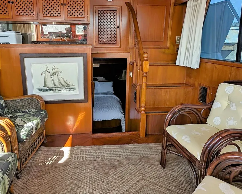 Slide: The Image of Interior of 1986 Heritage East 40 Sundeck with wooden decor and wicker furniture. - 30