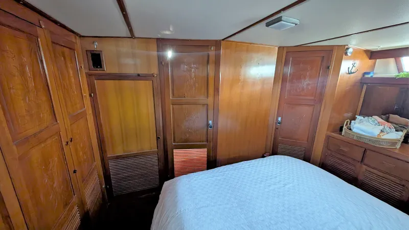 Slide: The Image of 1986 Heritage East 40 Sundeck interior with wooden paneling and cozy bedroom. - 33