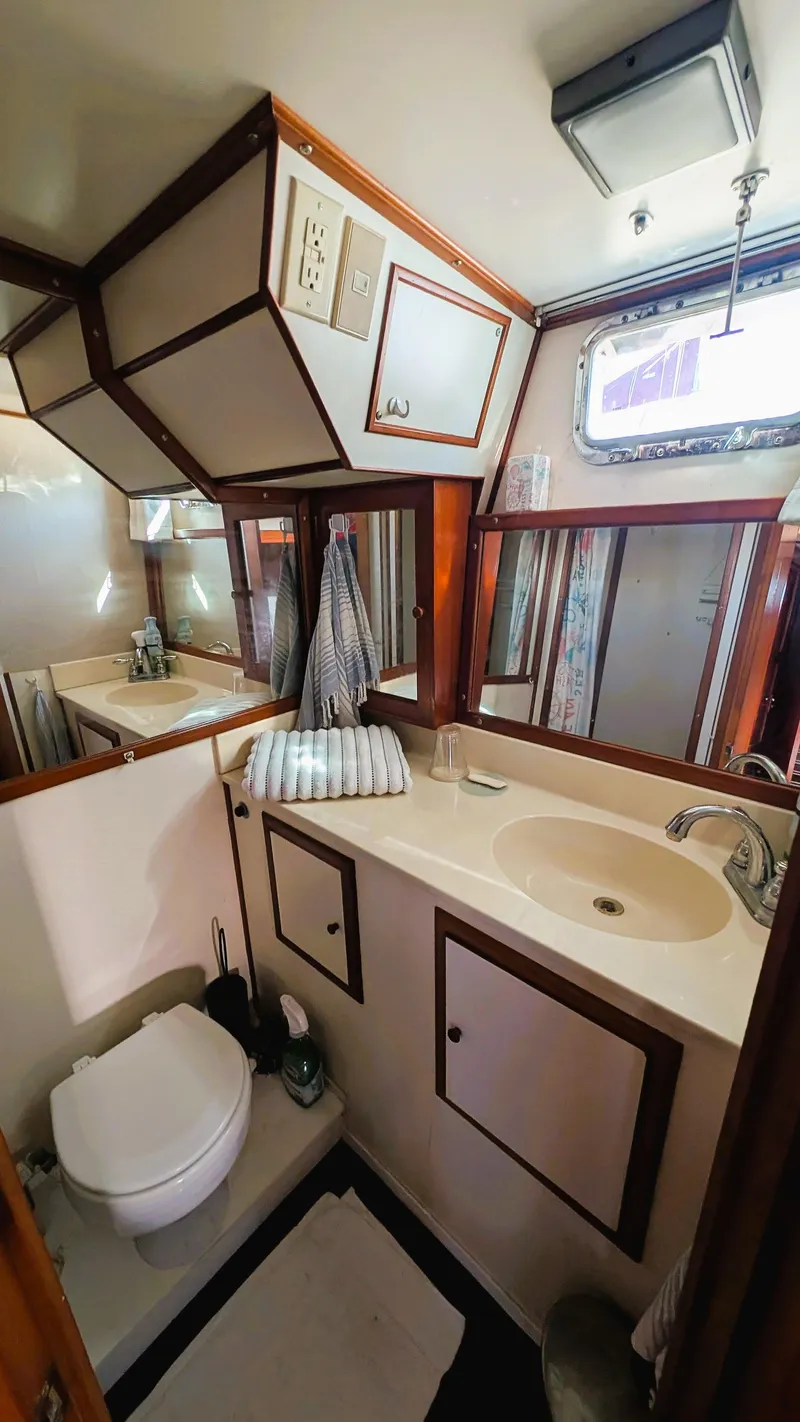 Slide: The Image of 1986 Heritage East 40 Sundeck bathroom with sink, toilet, and mirror. - 34