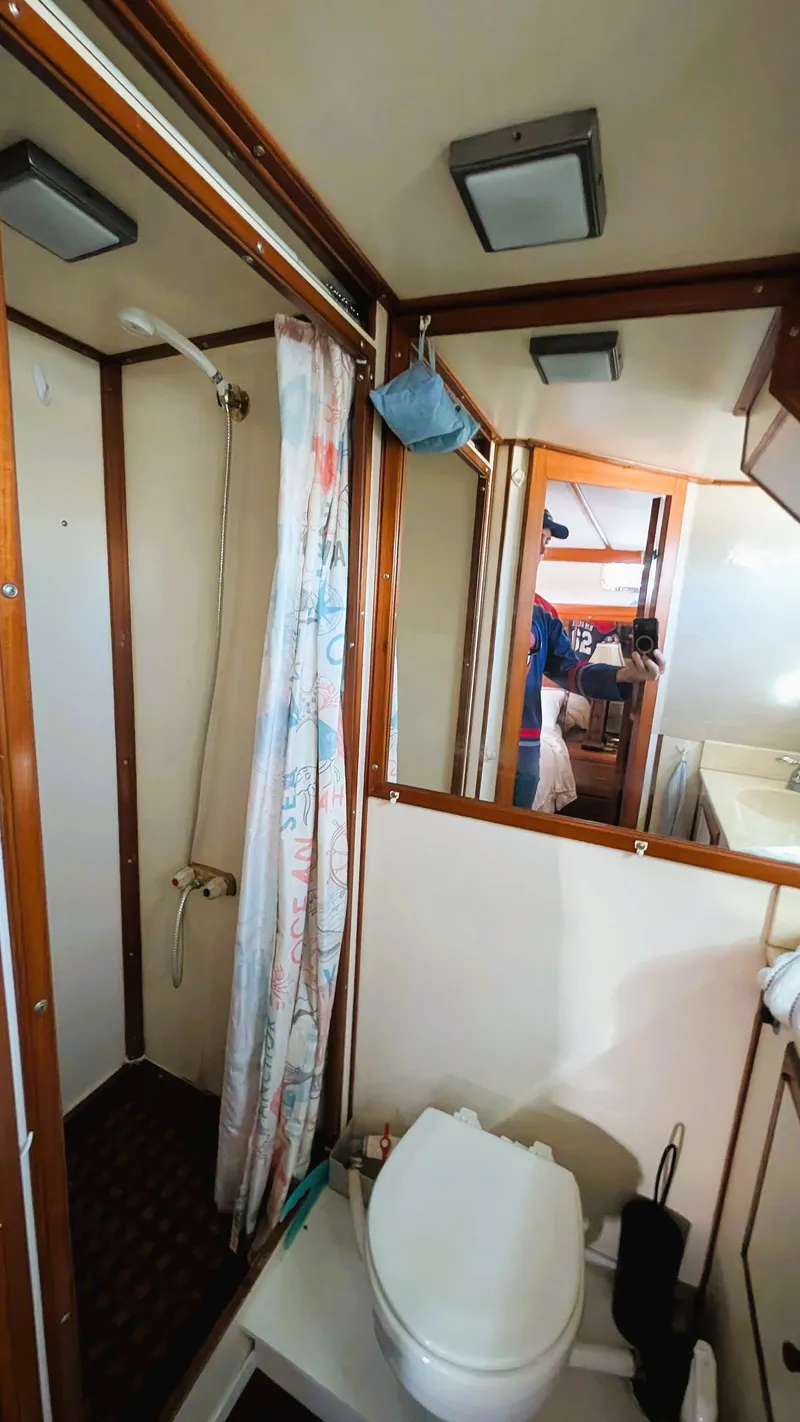 Slide: The Image of 1986 Heritage East 40 Sundeck bathroom with shower, toilet, and mirror. - 35