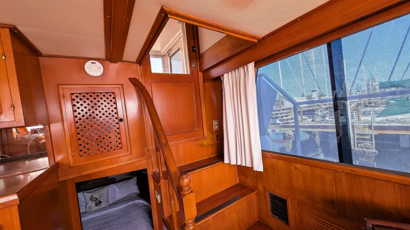 Slide: The Image of Interior of 1986 Heritage East 40 Sundeck with wooden finish and marina view. - 37