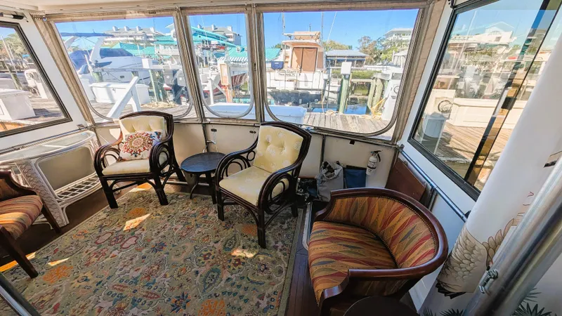 Slide: The Image of Interior of 1986 Heritage East 40 Sundeck with cozy seating and marina view. - 39