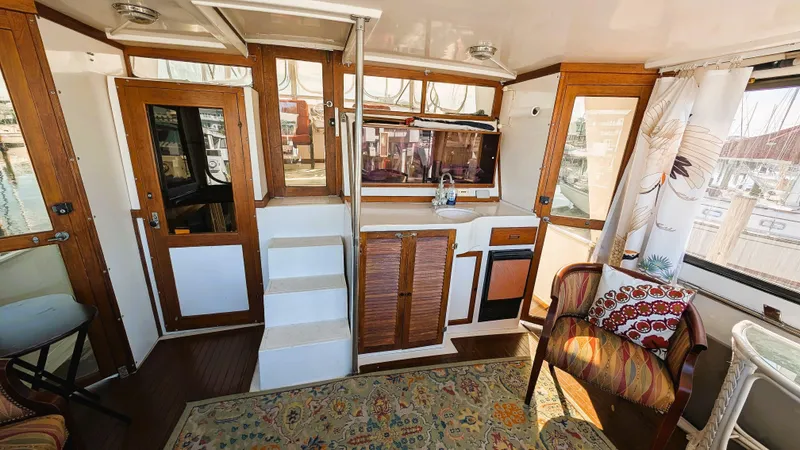 Slide: The Image of Interior of 1986 Heritage East 40 Sundeck yacht with wood accents and cozy seating. - 41
