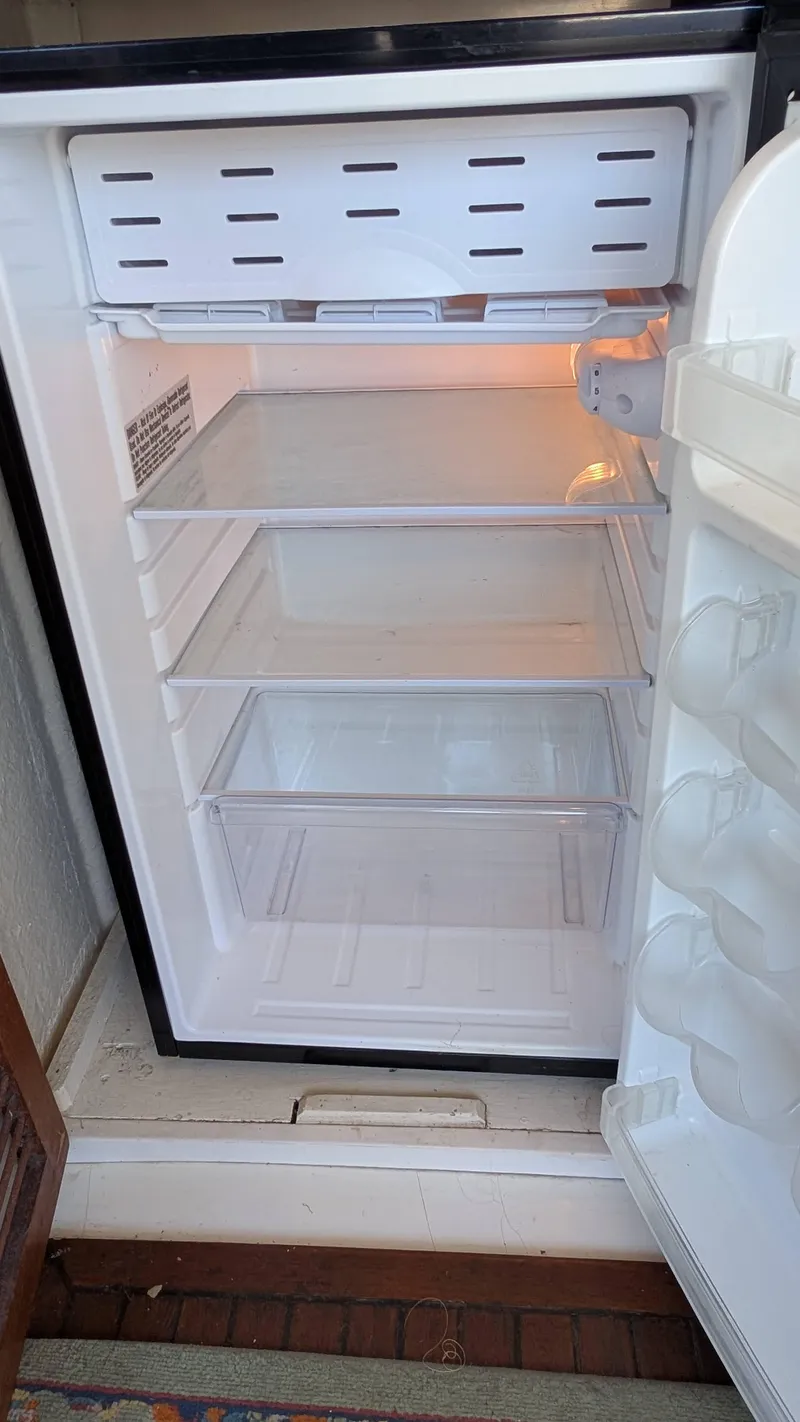 Slide: The Image of Empty refrigerator inside a 1986 Heritage East 40 Sundeck boat. - 43