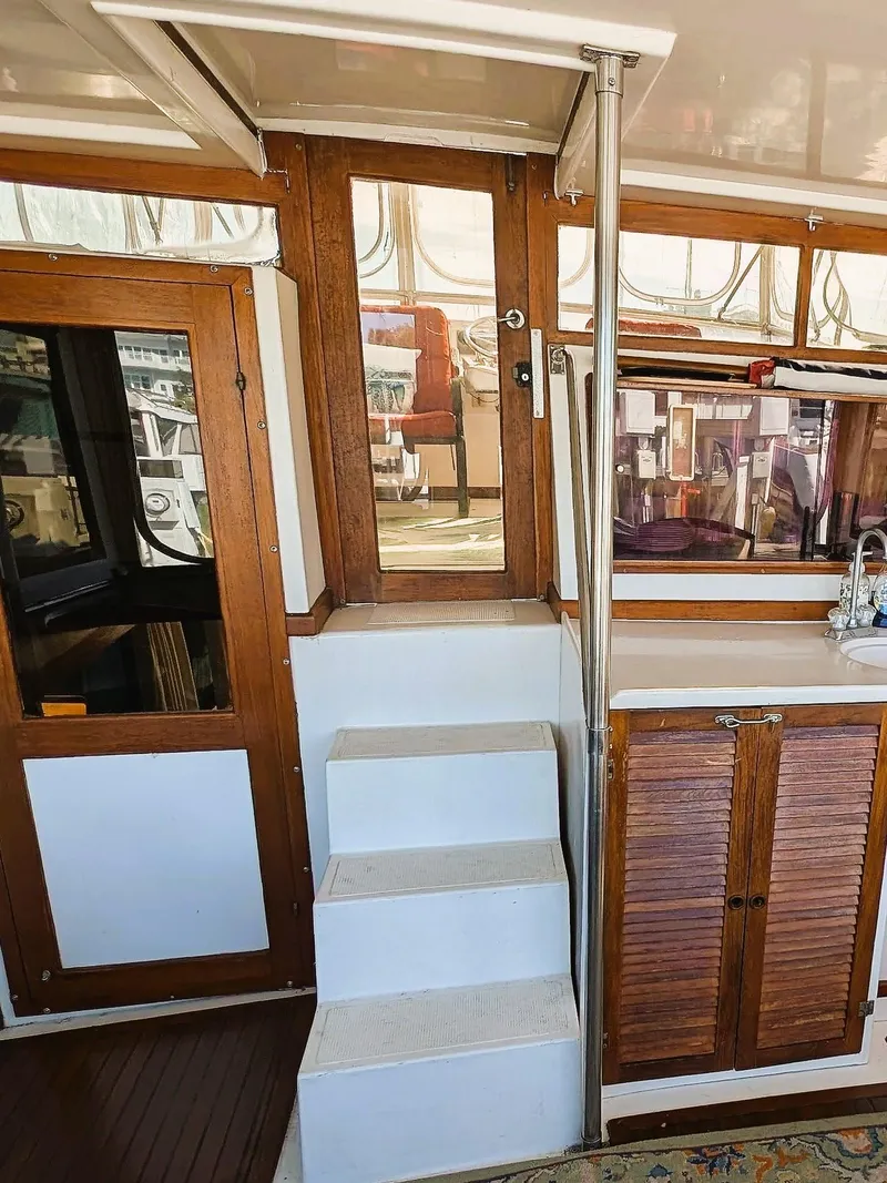 Slide: The Image of Interior view of 1986 Heritage East 40 Sundeck yacht with wooden accents and steps. - 44