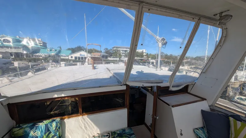 Slide: The Image of 1986 Heritage East 40 Sundeck interior view with marina backdrop. - 47