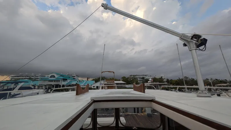 Slide: The Image of 1986 Heritage East 40 Sundeck yacht with cloudy sky and marina backdrop. - 48