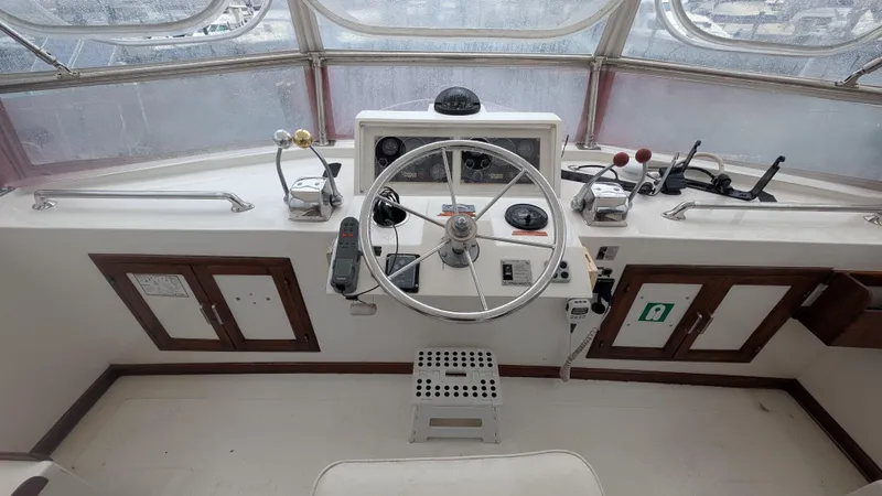 Slide: The Image of 1986 Heritage East 40 Sundeck helm with steering wheel and control panel. - 49