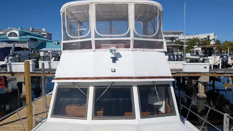 Slide: The Image of 1986 Heritage East 40 Sundeck yacht docked at marina, clear blue sky background. - 5