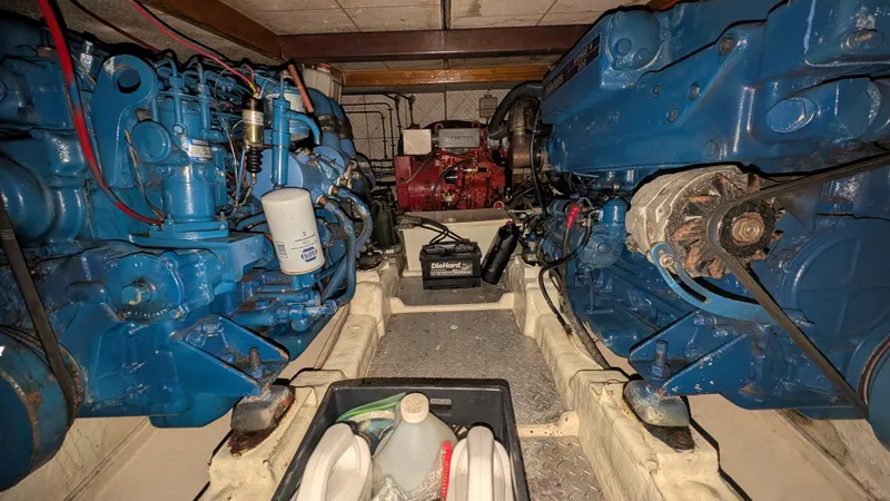 Slide: The Image of Engine room of 1986 Heritage East 40 Sundeck with blue machinery and maintenance supplies. - 54