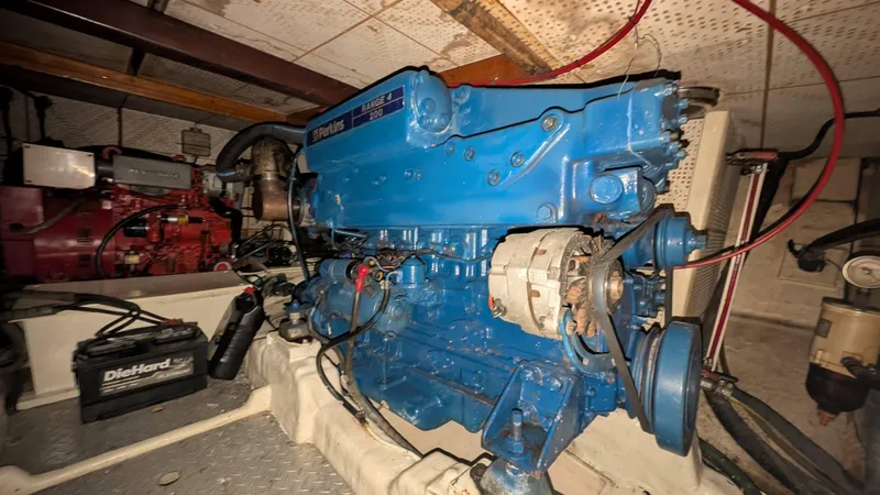 Slide: The Image of Engine room of 1986 Heritage East 40 Sundeck with Perkins engine and DieHard battery. - 55