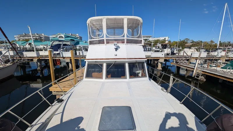 Slide: The Image of 1986 Heritage East 40 Sundeck yacht docked at marina under clear blue sky. - 7