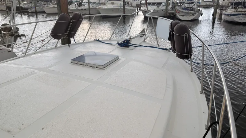 Slide: The Image of 1986 Heritage East 40 Sundeck yacht docked at marina, showcasing spacious deck. - 8