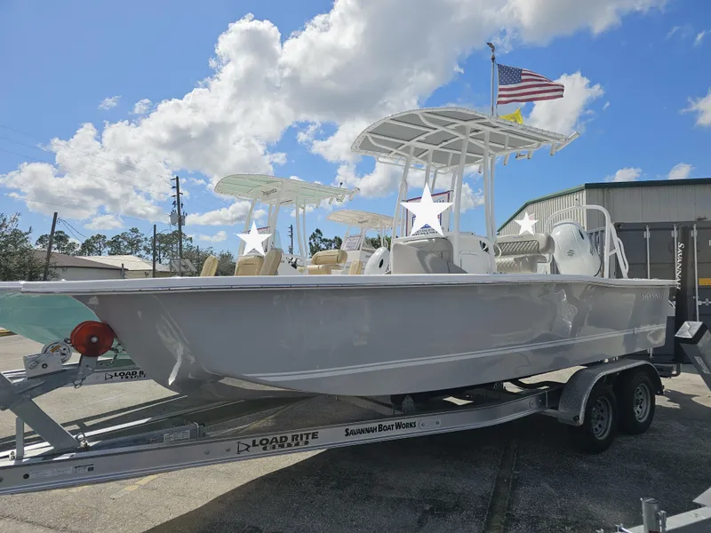 The Image of 2025 Savannah SS21 boat on trailer under blue sky with clouds. - 0