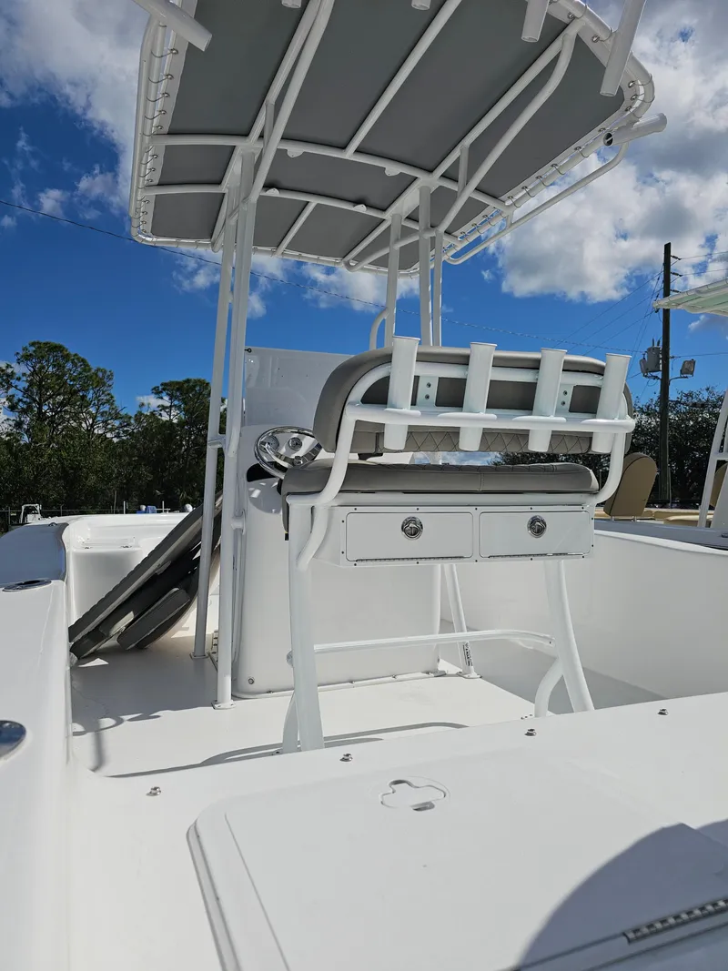 Slide: The Image of 2025 Savannah SS21 boat with T-top, white deck, and seating under a clear blue sky. - 10