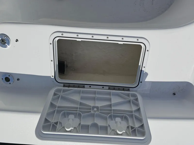 Slide: The Image of Open storage compartment on a 2025 Savannah SS21 boat, showcasing interior space. - 14
