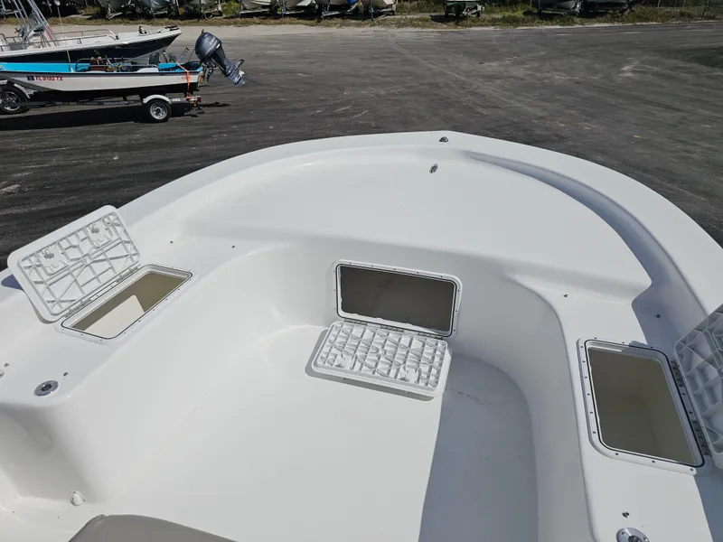 Slide: The Image of 2025 Savannah SS21 boat deck with open storage compartments, parked on a lot. - 15