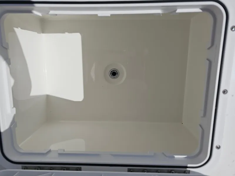 Slide: The Image of Empty storage compartment of a 2025 Savannah SS21 boat, featuring a drain at the bottom. - 17