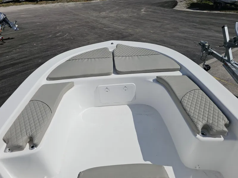 Slide: The Image of 2025 Savannah SS21 boat interior with cushioned seating and diamond-pattern upholstery. - 2