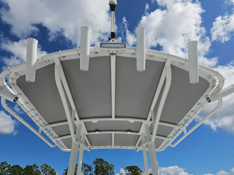 Slide: The Image of T-top of 2025 Savannah SS21 boat against a blue sky with clouds. - 20