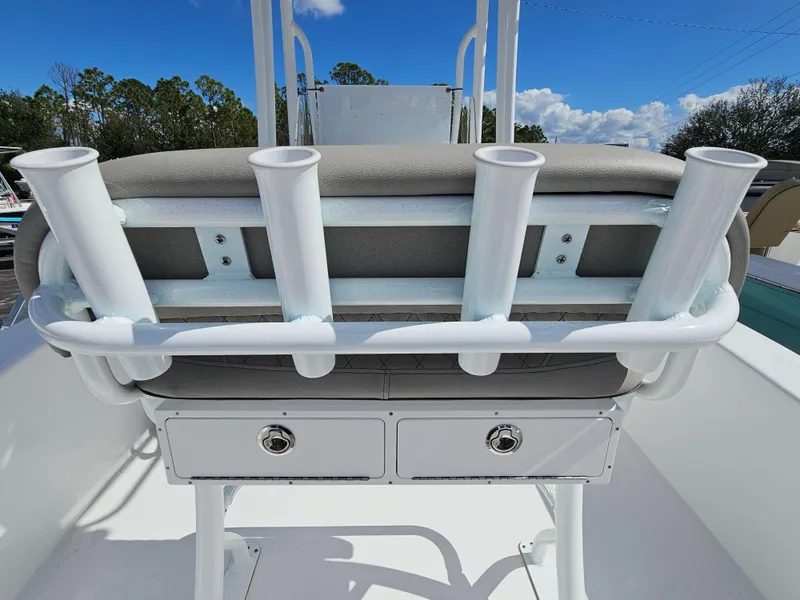 Slide: The Image of Savannah SS21 2025 boat seat with rod holders and storage drawers, under a clear blue sky. - 22