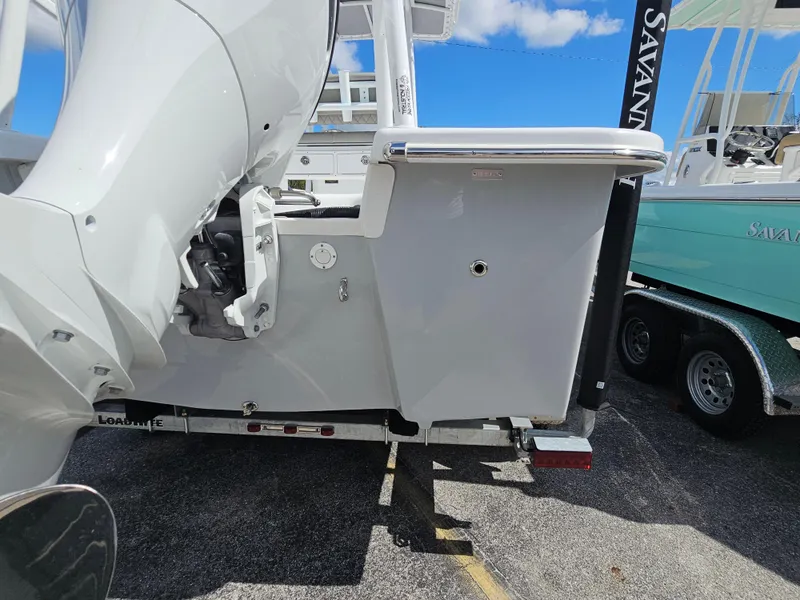 Slide: The Image of 2025 Savannah SS21 boat on trailer, showcasing rear view and motor details. - 23